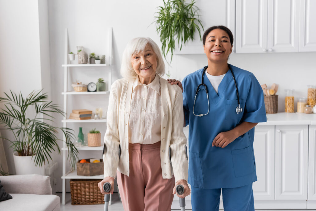 A home health professional standing beside an older adult